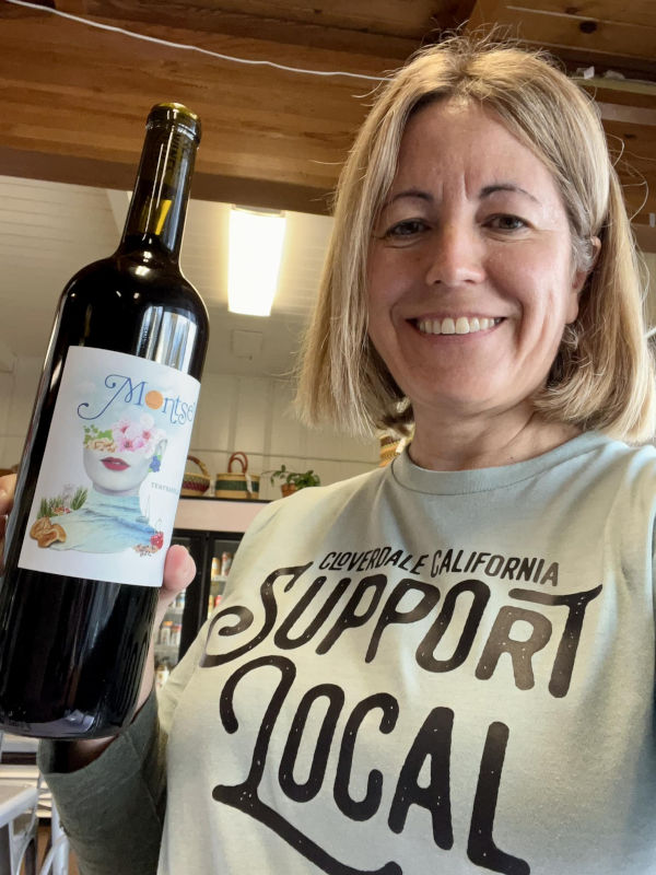 Montse Reece with a red wine bottle